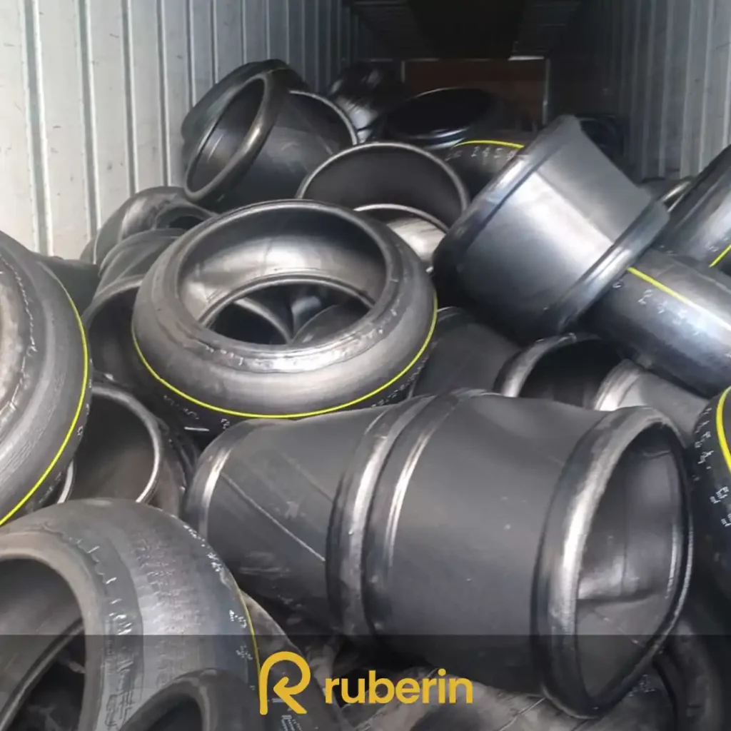 Used tire carcasses stacked in bulk, selected for retreading or raw material recovery in rubber processing.