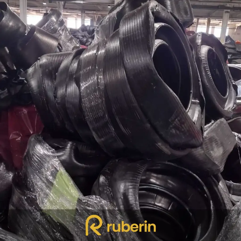 Uncured green tire material stacked on pallets, sourced from production surplus for recycling or rubber reclaim.