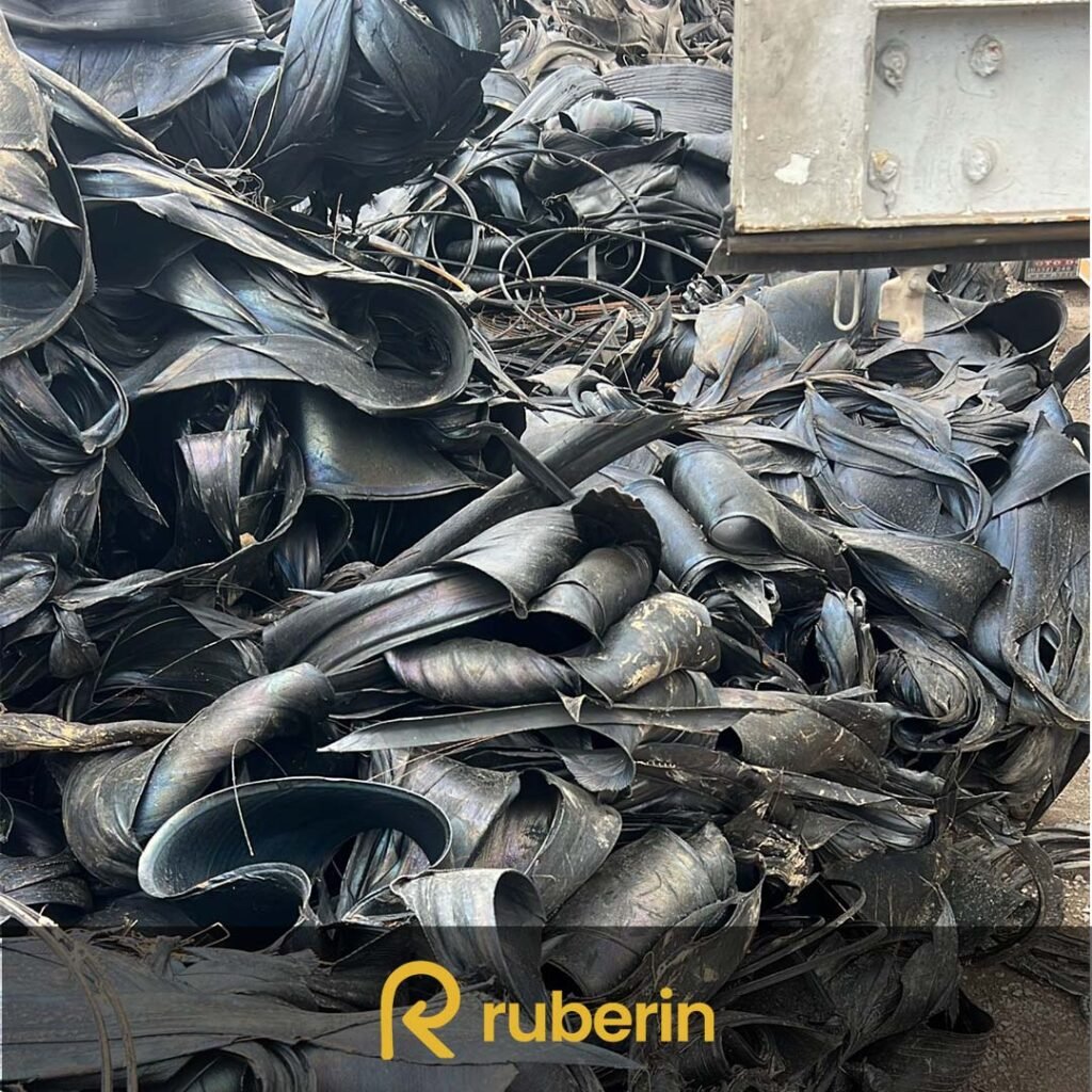 Steel friction rubber scrap pile with visible embedded steel wires and worn rubber layers, used in industrial recycling and material reclaim processes