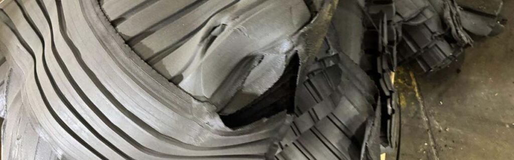 Stacked rubber compound profiles with grooved patterns, showcasing processed rubber materials ready for finishing or cutting.